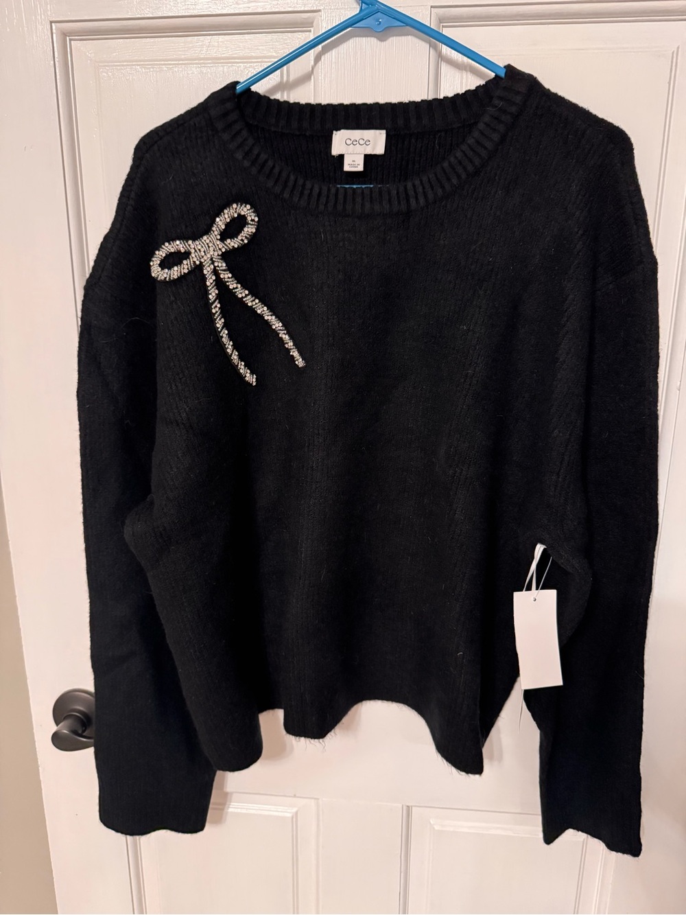 CeCe Black Crewneck Sweater with Crystal Bow Accent